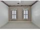 Well lit bedroom with light colored walls and light colored carpet at 2382 Merrymount Dr, Suwanee, GA 30024