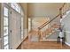 Elegant foyer with hardwood floors, staircase, and lots of natural light at 2382 Merrymount Dr, Suwanee, GA 30024