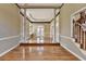 Elegant foyer featuring hardwood floors, decorative columns, and a grand staircase leading to the upper level at 2382 Merrymount Dr, Suwanee, GA 30024