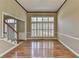 Inviting foyer with hardwood floors, staircase, large window with shutters, and neutral paint, creating a warm and welcoming space at 2382 Merrymount Dr, Suwanee, GA 30024