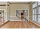 Open foyer featuring hardwood floors, staircase, large windows with shutters, and neutral paint, creating a bright and inviting space at 2382 Merrymount Dr, Suwanee, GA 30024