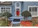 Charming front entrance with a vibrant red door and manicured bushes at 2382 Merrymount Dr, Suwanee, GA 30024