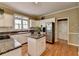 Updated kitchen features stainless appliances, granite countertops, and a center island at 2382 Merrymount Dr, Suwanee, GA 30024