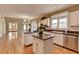 Spacious kitchen boasts stainless appliances, granite countertops, and an open floor plan at 2382 Merrymount Dr, Suwanee, GA 30024