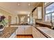Updated kitchen with granite countertops, stainless steel appliances, and view to an open floor plan at 2382 Merrymount Dr, Suwanee, GA 30024