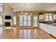 Eat-in kitchen featuring granite counters, white cabinets and a living room with a fireplace beyond at 2382 Merrymount Dr, Suwanee, GA 30024