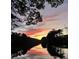 Colorful sunset over lake and treeline at 2382 Merrymount Dr, Suwanee, GA 30024