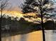 Stunning lake view during a golden sunset, showcasing the serene surroundings at 2382 Merrymount Dr, Suwanee, GA 30024
