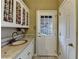 Well-equipped laundry room with a sink, patterned tilework, access door, and ample storage at 2382 Merrymount Dr, Suwanee, GA 30024