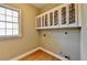 Practical laundry room with wall cabinets and a window for natural light at 2382 Merrymount Dr, Suwanee, GA 30024
