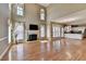 Bright living room with fireplace, large windows, and open access to the kitchen, creating a comfortable and inviting atmosphere at 2382 Merrymount Dr, Suwanee, GA 30024
