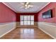 Elegant living room featuring hardwood floors, a ceiling fan, and a large window with shutters at 2382 Merrymount Dr, Suwanee, GA 30024