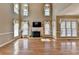 Bright living room with fireplace, large windows, and hardwood floors, creating a warm and inviting atmosphere at 2382 Merrymount Dr, Suwanee, GA 30024