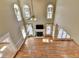 Living room features hardwood floors, tall ceilings, large bright windows, and a cozy fireplace at 2382 Merrymount Dr, Suwanee, GA 30024