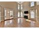 Spacious living room with fireplace, tall windows, and open access to the dining room, creating a harmonious living space at 2382 Merrymount Dr, Suwanee, GA 30024