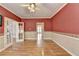 Spacious living room featuring hardwood floors, open entry ways, and a large window at 2382 Merrymount Dr, Suwanee, GA 30024