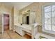 Spacious bathroom with a jetted tub, vanity with a large mirror, and tile floors at 2382 Merrymount Dr, Suwanee, GA 30024