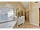 Spacious bathroom featuring a jetted tub, vanity, glass enclosed shower and tile floors at 2382 Merrymount Dr, Suwanee, GA 30024