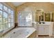 Bright bathroom featuring a jetted tub, vanity with storage, tile floors and access to a glass enclosed shower at 2382 Merrymount Dr, Suwanee, GA 30024