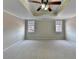 Primary bedroom has a tray ceiling with a fan and windows for plenty of natural light at 2382 Merrymount Dr, Suwanee, GA 30024
