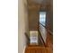 Staircase with hardwood floors and white banisters leading downstairs at 2382 Merrymount Dr, Suwanee, GA 30024