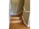 Wooden staircase with white trim leading to the upper level at 2382 Merrymount Dr, Suwanee, GA 30024