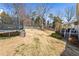 Large backyard featuring a trampoline, playset, and a covered deck at 3176 Crestmont Nw Way, Kennesaw, GA 30152