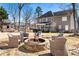 Outdoor living space featuring a fire pit with seating and a playset surrounded by trees at 3176 Crestmont Nw Way, Kennesaw, GA 30152