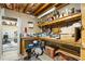Unfinished basement workshop space featuring a workbench, storage shelves, and tools at 3176 Crestmont Nw Way, Kennesaw, GA 30152