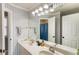 Bright bathroom featuring a double sink vanity, striped wallpaper and a large mirror at 3176 Crestmont Nw Way, Kennesaw, GA 30152