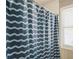 Bathroom shower with a decorative blue and white patterned curtain and a window at 3176 Crestmont Nw Way, Kennesaw, GA 30152