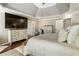 This bedroom is decorated with neutral tones, a tray ceiling, and has a large television on top of a wooden dresser at 3176 Crestmont Nw Way, Kennesaw, GA 30152