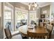 Bright breakfast nook with outdoor views, warm wood table, and coffee bar at 3176 Crestmont Nw Way, Kennesaw, GA 30152