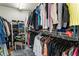 Spacious walk-in closet featuring ample storage with clothing racks, shelves, and a comfortable seat for convenience at 3176 Crestmont Nw Way, Kennesaw, GA 30152