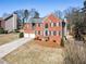 Attractive red brick home with black shutters, two-car garage, and nicely landscaped front yard at 3176 Crestmont Nw Way, Kennesaw, GA 30152
