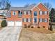Eye-catching red brick home with a spacious driveway and well-maintained front yard at 3176 Crestmont Nw Way, Kennesaw, GA 30152