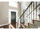 Bright foyer with hardwood floors, staircase with decorative wrought iron spindles and black front door at 3176 Crestmont Nw Way, Kennesaw, GA 30152
