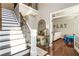 Foyer with stairs and a glimpse of a living area with hardwood flooring and neutral walls at 3176 Crestmont Nw Way, Kennesaw, GA 30152