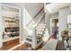 Sunlit foyer with hardwood floors and a staircase with decorative wrought iron spindles at 3176 Crestmont Nw Way, Kennesaw, GA 30152
