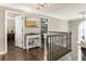 Inviting hallway featuring hardwood floors, elegant lighting, and views of the surrounding rooms on the second floor at 3176 Crestmont Nw Way, Kennesaw, GA 30152