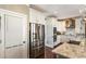 A modern kitchen with stainless steel appliances, white cabinets, granite countertops, and wood floors at 3176 Crestmont Nw Way, Kennesaw, GA 30152