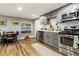 Basement kitchen with gray cabinetry, stainless steel appliances, and hardwood floors at 3176 Crestmont Nw Way, Kennesaw, GA 30152