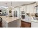 Bright kitchen with stainless steel appliances, granite countertops, and an island that has pendant lighting at 3176 Crestmont Nw Way, Kennesaw, GA 30152