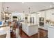 Open-concept kitchen with a large center island, stainless steel appliances, and view into the living room at 3176 Crestmont Nw Way, Kennesaw, GA 30152