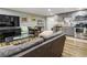 Basement living room and kitchen with hardwood floors, sofa, table, and stainless steel appliances at 3176 Crestmont Nw Way, Kennesaw, GA 30152