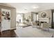 An open-concept room with dark hardwood floors, gray paint and a desk and fireplace sitting area at 3176 Crestmont Nw Way, Kennesaw, GA 30152