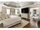 Main bedroom featuring a tray ceiling, hardwood flooring, and neutral walls and furnishings at 3176 Crestmont Nw Way, Kennesaw, GA 30152