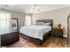 Comfortable bedroom with neutral walls, hardwood floors, natural light, and classic furnishings and decor at 3176 Crestmont Nw Way, Kennesaw, GA 30152