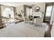 A sitting room with hardwood floors, natural lighting, a fireplace, and comfortable seating at 3176 Crestmont Nw Way, Kennesaw, GA 30152