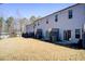 A spacious backyard features a lawn and access to the townhouse via a sliding glass door at 5652 Plain Field Ln, Lilburn, GA 30047